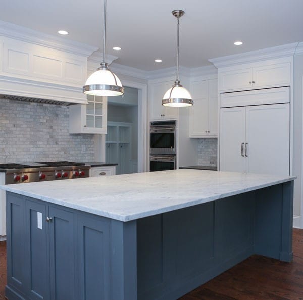 Dark, gray, blue cabinets with light gray kitchen countertops