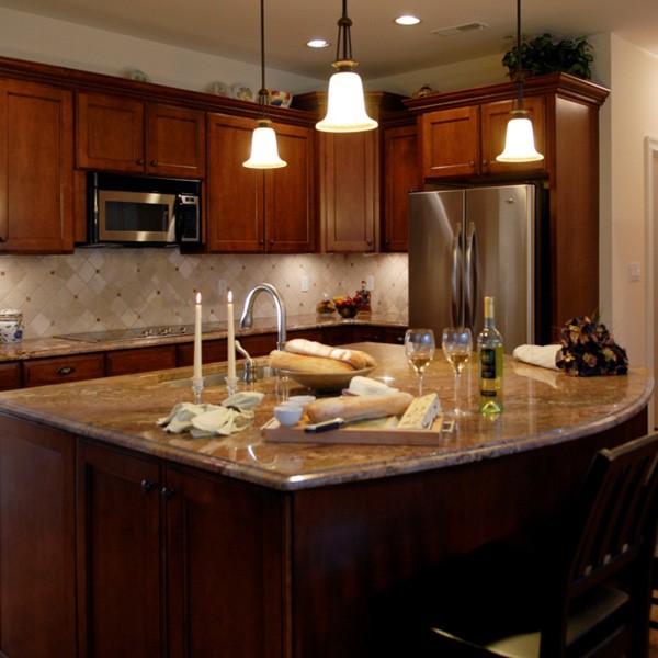 Dark wood cabinets with tan kitchen countertops